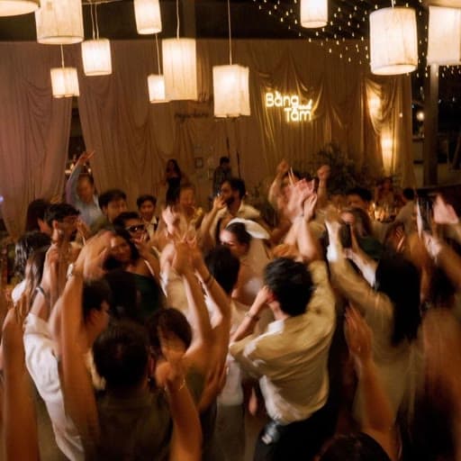 Wedding reception dance floor lit by hanging lanterns, photographed by a guest